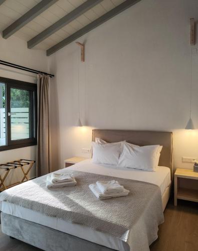 a bedroom with a bed with two towels on it at Kaia Studios Agnondas in Agnontas