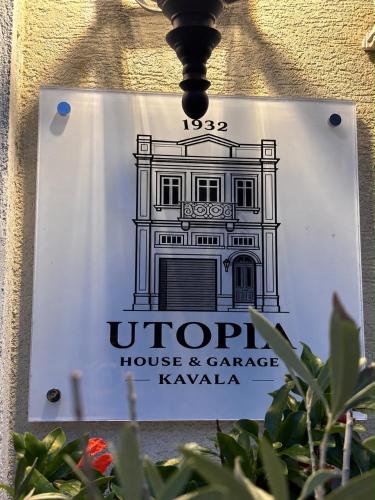 a sign for an uptop house and carriage kavala at Utopia House & Garage in Kavála