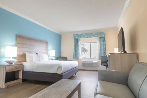 a hotel room with a bed and a couch at Amelia Hotel at the Beach in Fernandina Beach