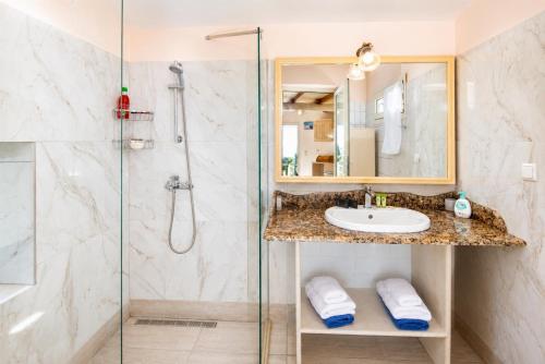 a bathroom with a shower and a sink at Villa Windmill in Vlachopoulátika
