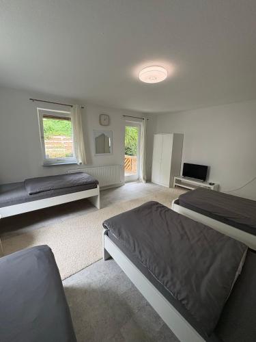 a large bedroom with two beds and a television at Home15 Kassel in Kassel