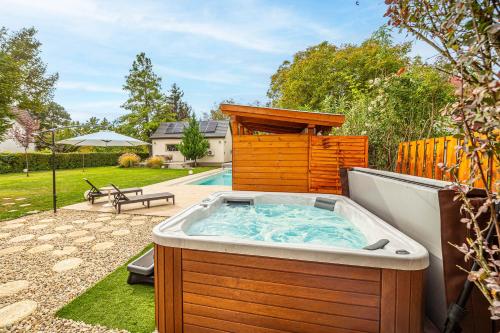 a hot tub in the backyard of a house at Lime weekendhouse 1-2 in Balatonakarattya