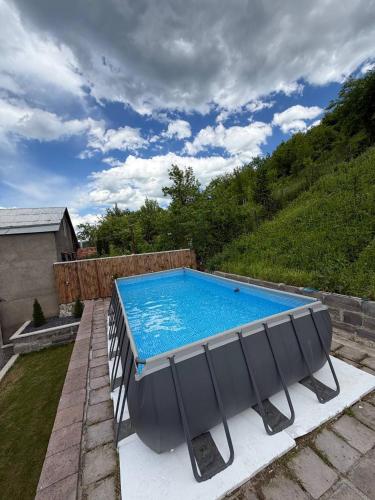 a swimming pool sitting on top of a patio at DiliOne Guest House in Dilijan