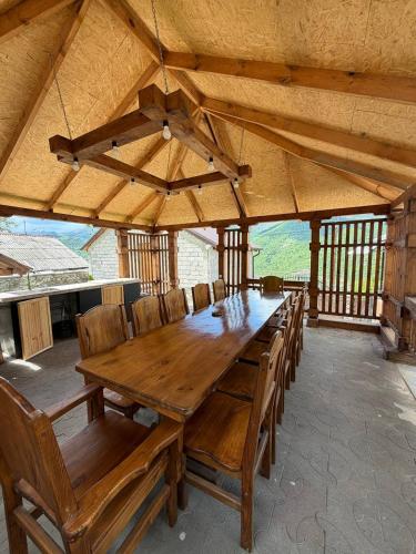 a large wooden table and chairs in a pavilion at DiliOne Guest House in Dilijan