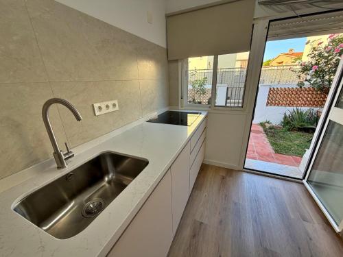 a kitchen with a sink and a large window at El Hidalgo Costa del Sol in Torre de Benagalbón
