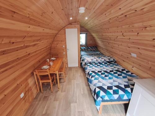 a room with two beds and a table in it at Barrhill Holiday Park - Glamping in South West Scotland - Stinchar in Girvan