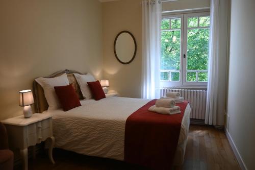 a bedroom with a large bed and a window at Chambre d'Hôtes Le Moulin Bertrand in Saint-Martin-de-Ribérac