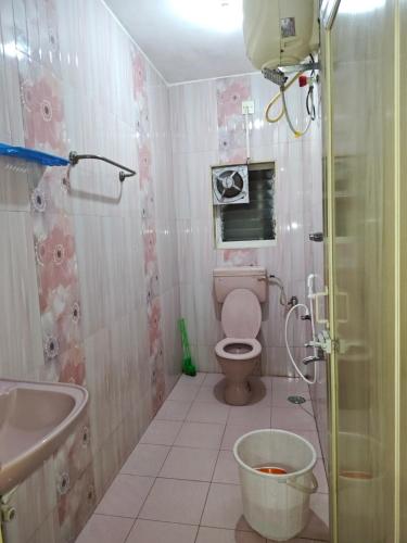 a bathroom with a toilet and a tub and a sink at SEYONE stay in Kanchipuram