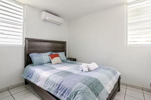 a bedroom with a bed with two towels on it at The Mango House in Fajardo