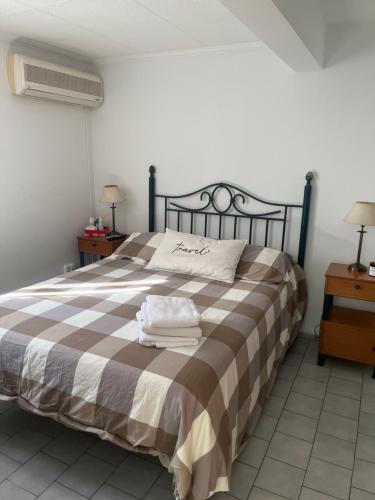 a bedroom with a bed with two towels on it at Corro 8 in Córdoba