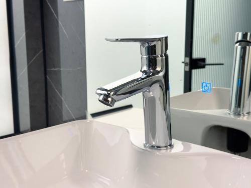a sink with a faucet in a bathroom at Hotel Fazenda Terra dos Sonhos in Bueno Brandão