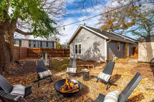 a backyard with a fire pit and chairs and a house at Backyard Hangout Firepit Giant Connect 4 & BBQ in Raleigh