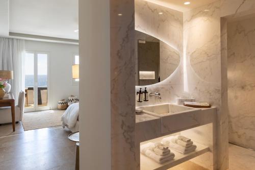 a bathroom with a sink and a mirror at Casa Kiku Mykonos in Mikonos