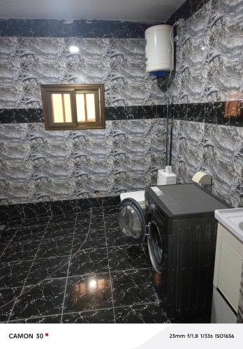 a bathroom with a washing machine in a room at sea flower in Lomé