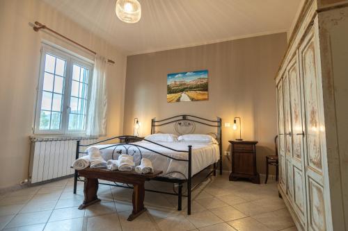 a bedroom with a bed and a table with shoes on it at TORRE QUADRANA in Spello