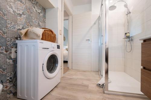a bathroom with a washing machine and a shower at RossoMattone CountryHouse in Sulmona