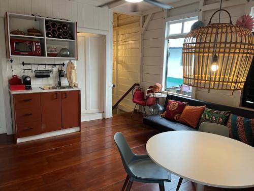 a living room with a table and a bird cage at Coffee Mama Stay in Paramaribo