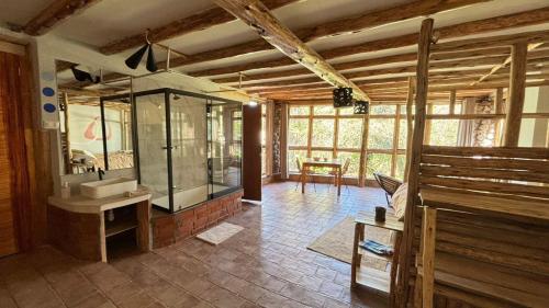 a bathroom with a glass shower and a sink at Casa de campo Yoga Retreat in Urubamba