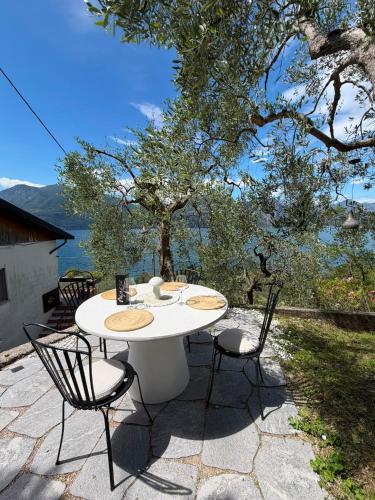 a white table and chairs sitting on a patio at Casa Agnese Lake View in Brenzone sul Garda