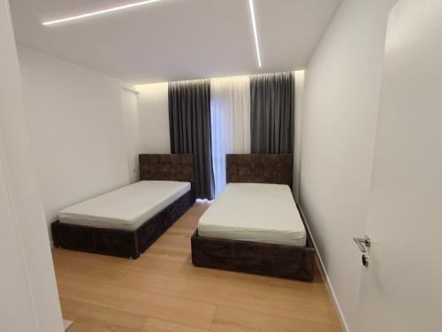 a room with two beds and a window at DfA in Tirana