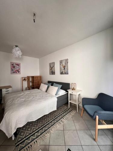 a bedroom with a bed and a couch and a chair at Hygge Cabin in Rostock