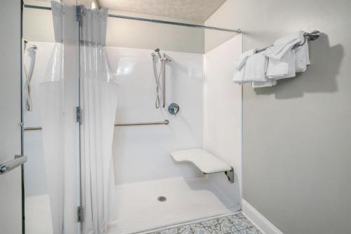 a white bathroom with a shower and a sink at Best Western Fredericksburg in Fredericksburg