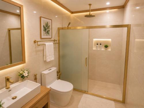 a bathroom with a shower and a toilet and a sink at Handhuvaru Maldives in Milandu