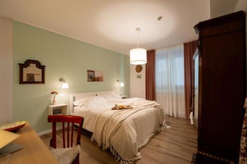 a bedroom with a bed and a table and a table sidx sidx sidx at RossoMattone CountryHouse in Sulmona