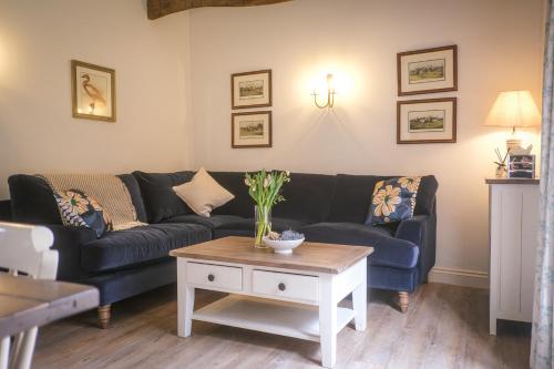 a living room with a couch and a coffee table at Oaters Wood in Petworth