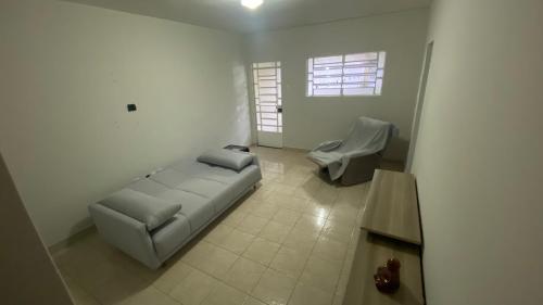 a living room with a couch and a chair at Jardim Teresa - Até 10 pessoas, próximo ao Açude Velho, Centro Histórico e Parque do Povo in Campina Grande
