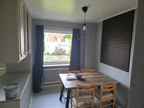 a dining room table with two chairs and a window at Seaside Koster house in Strömstad