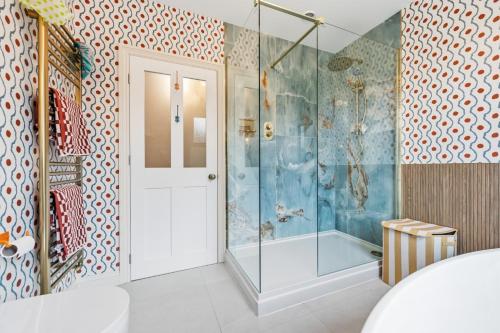 a bathroom with a shower and a glass door at Hillsley House in Wirksworth