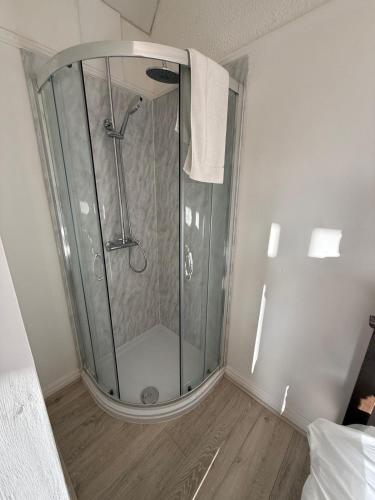 a shower with a glass door in a bathroom at Short Stay & Long Stay home in Ellesmere Port in Little Sutton