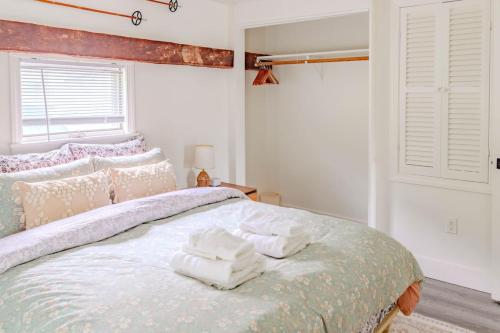 a bedroom with a bed with towels on it at Cute Stowe Apartment in Stowe