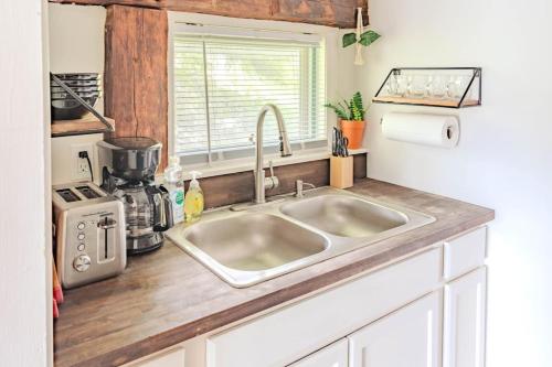 a kitchen counter with a sink in a kitchen at Cute Stowe Apartment in Stowe