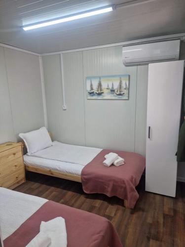 two beds in a small room with sails on the wall at Bungalows Rea in Burgas