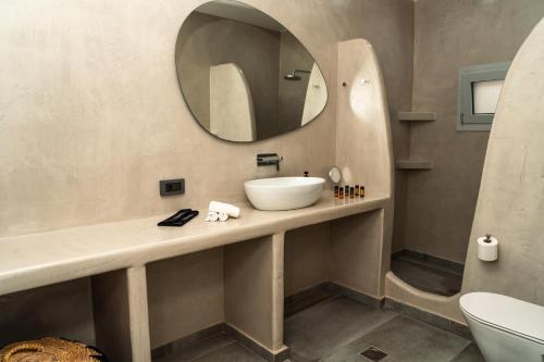 a bathroom with a sink and a mirror at Erimo Vip in Vourvoúlos