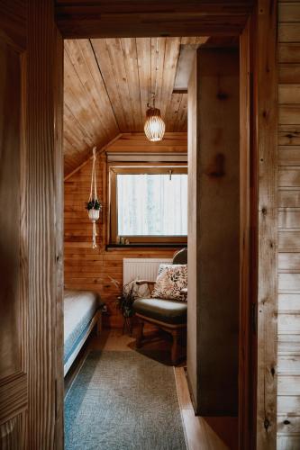 a small room with a bed and a window at Piparmētras in Mērsrags