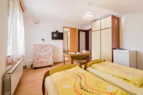 a small room with two beds and a desk at Turistična kmetija Široko in Tolmin