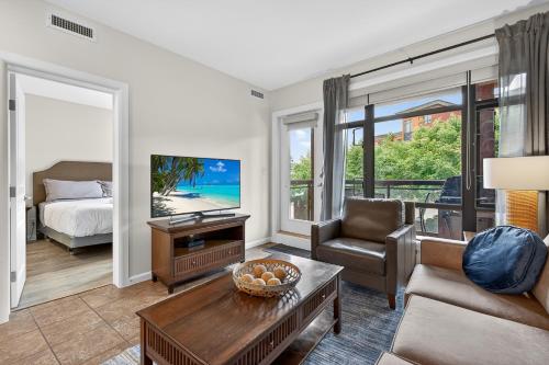 a living room with a couch and a table at Luxury Playa Del Sol Condo 435 w Pool, Hot Tub & Beach Nearby in Kelowna