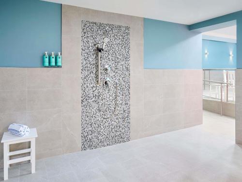 a shower in a bathroom with a wall at Novotel Toronto North York in Toronto