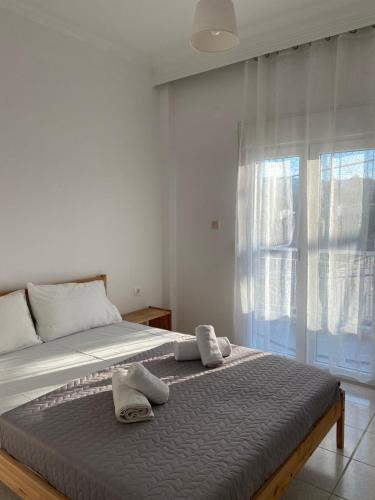 a bedroom with a large bed with towels on it at Georgia's House Olympiada in Olympiada
