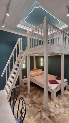 a bedroom with a bunk bed and a staircase at Vinnytsia City Center Guest House in Vinnytsya