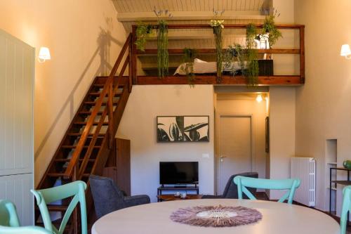 a room with a table and chairs and a staircase at Lues Garden in Ragusa