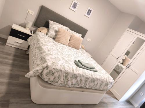 a bedroom with a bed with a white comforter at Casa Nentis in Mucientes