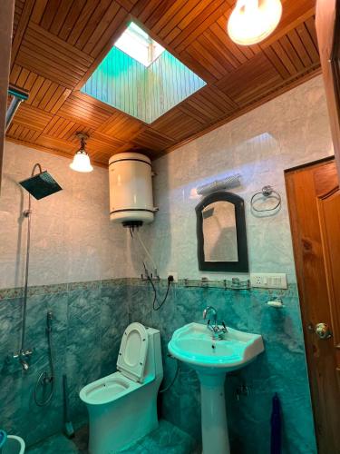 a bathroom with a sink and a toilet and a sink at Zakiyas Homestay in Srinagar