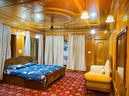 a bedroom with a bed and a chair in a train at Zakiyas Homestay in Srinagar