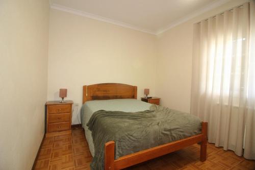 a bedroom with a bed and a dresser and a window at Paraíso do Gerês in Geres