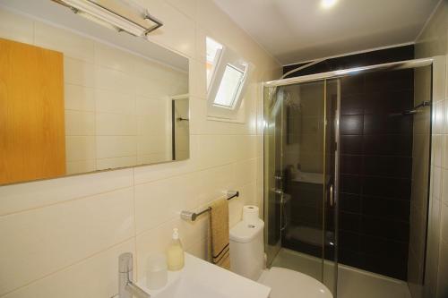 a bathroom with a shower and a toilet and a sink at Paraíso do Gerês in Geres