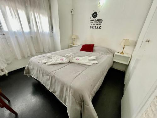 a bedroom with a bed with two white bows on it at Hotel Astro in Mar del Plata